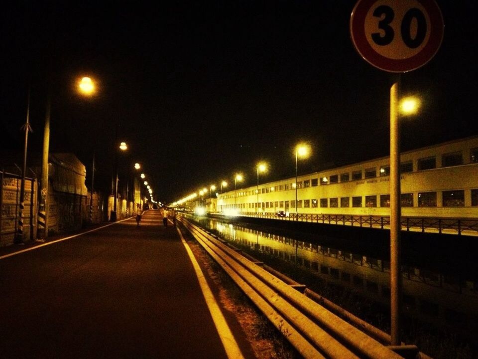 illuminated, night, the way forward, transportation, street light, lighting equipment, diminishing perspective, vanishing point, clear sky, built structure, railroad track, empty, architecture, road, long, rail transportation, copy space, outdoors, no people, street
