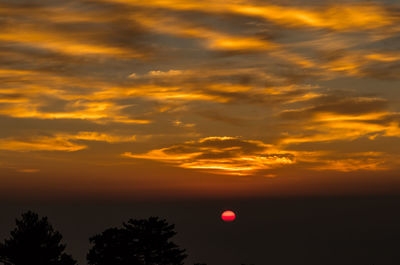 Low angle view of dramatic sky during sunset