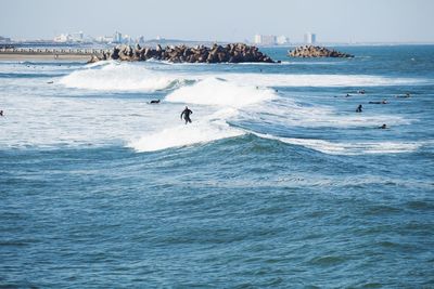 People surfing on sea