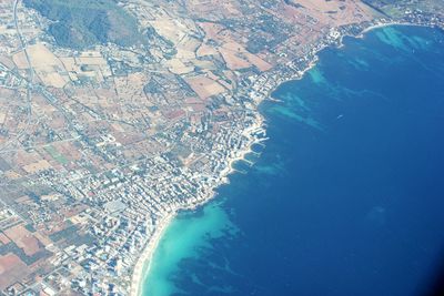 Aerial view of sea and cityscape