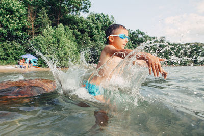 Full length of shirtless boy in swimming pool