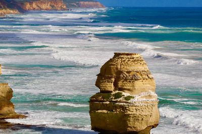 Scenic view of sea against rock formation