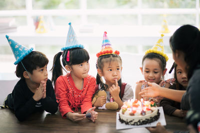 Cute happy friends enjoying birthday party at home