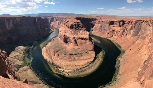 High angle view of rock formations by river against sky