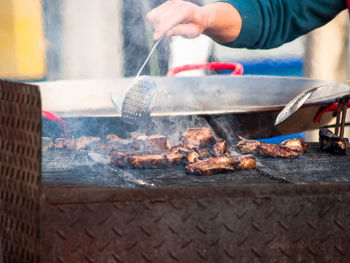 Man preparing food on barbecue grill