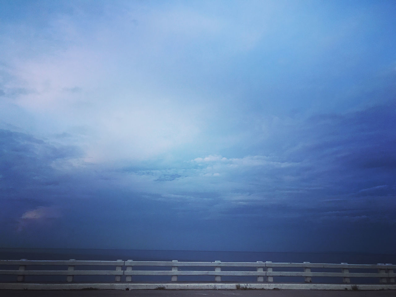 sky, horizon, sea, cloud, ocean, water, beauty in nature, nature, dusk, scenics - nature, horizon over water, tranquility, blue, no people, tranquil scene, sunlight, environment, coast, outdoors, evening, beach, idyllic, day, railing, wave, land