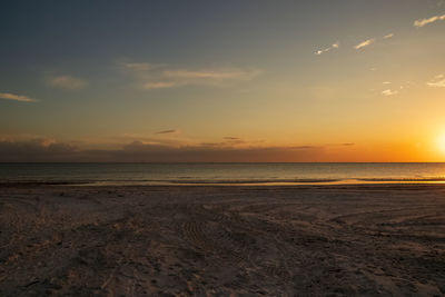Scenic view of beach against sky during sunset