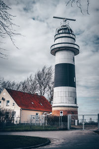 View of tower by building against sky