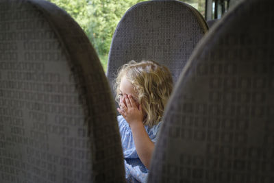 Portrait of girl against wall