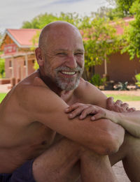 White senior man sitting, smiling