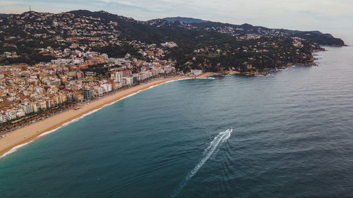 High angle view of buildings by sea against sky