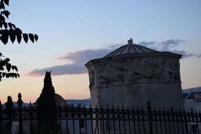 Traditional building against sky during sunset