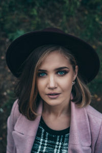 Portrait of beautiful young woman with hat outdoors