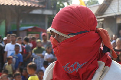 Rear view of man with red umbrella