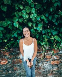 Portrait of a smiling young woman standing outdoors