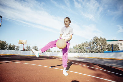 Golden hour glory, girl's basketball passion shines bright in the sun outdoors