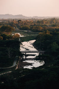 High angle view of lake in forest against sky