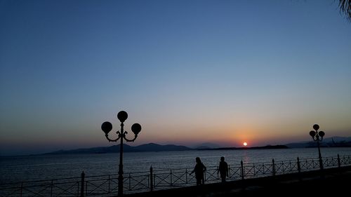 Pier on sea at sunset