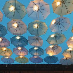 Low angle view of decorations hanging against sky at dusk