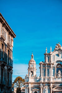 Low angle view of buildings against blue sky