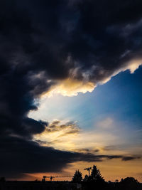 Low angle view of silhouette trees against sky during sunset