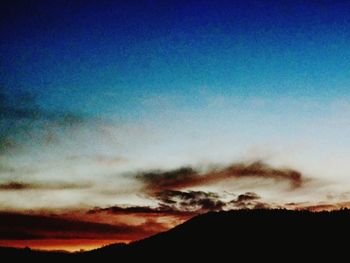 Scenic view of silhouette mountains against sky at sunset