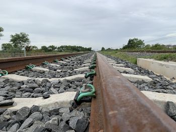 Surface level of railroad tracks against sky