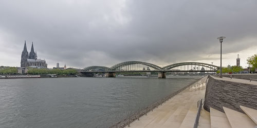 View of bridge over river against cloudy sky