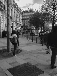 Man and woman walking on street in city