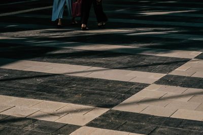 Low section of people walking on footpath