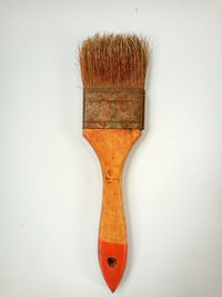 Directly above shot of paintbrushes against white background