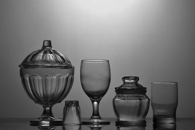 Close-up of glasses on table against white background