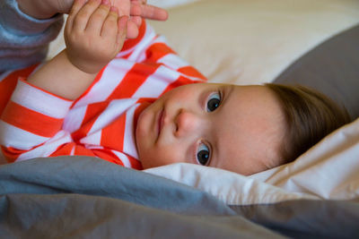 Portrait of cute baby boy .on bed at home