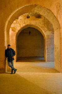 Full length of man standing by building