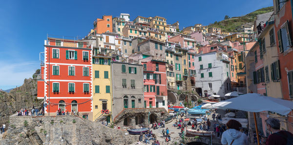 People on street amidst buildings in city