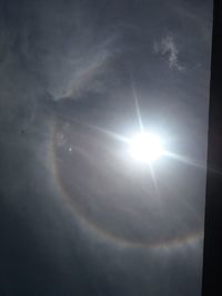 Low angle view of sun shining in sky