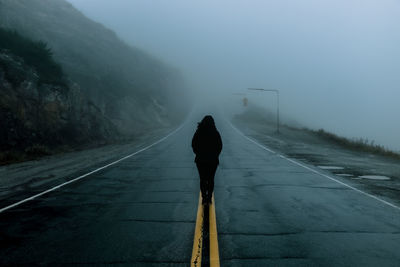 Rear view of man on road