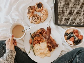 Woman having coffee and breakfast in bed