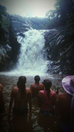 People enjoying in water against sky