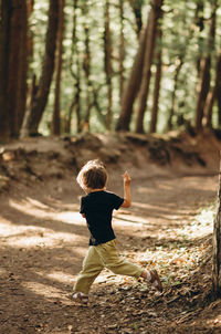 Rear view of boy in forest