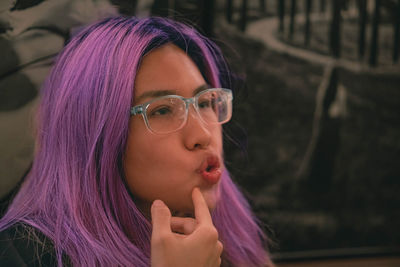 Purple hair woman with a funny facial expression