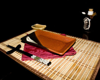 High angle view of books on table against black background