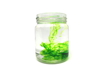 Close-up of drink in jar against white background