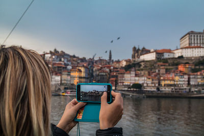 Woman photographing cityscape