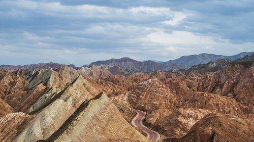 Danxia scenic view of mountains against cloudy sky