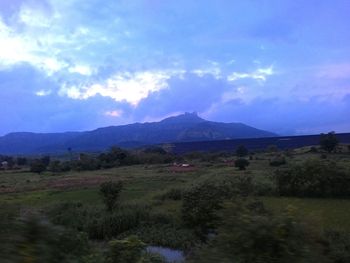 Countryside landscape against mountain range