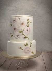 Close-up of pink roses on white table