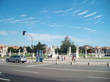 Cars on road in city against sky