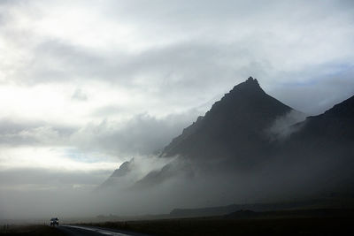 Scenic view of mountain against cloudy sky