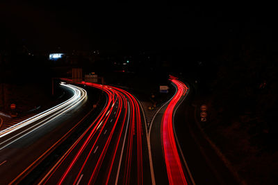 High angle view of light trails on road at night